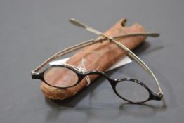 A small pair of 19th century tortoiseshell and white metal spectacles, cased. Width 11.5cm