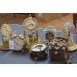 A group of five clocks including two 100 day clocks, a painted wooden wall-mounted cuckoo clock,