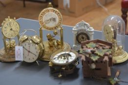 A group of five clocks including two 100 day clocks, a painted wooden wall-mounted cuckoo clock,