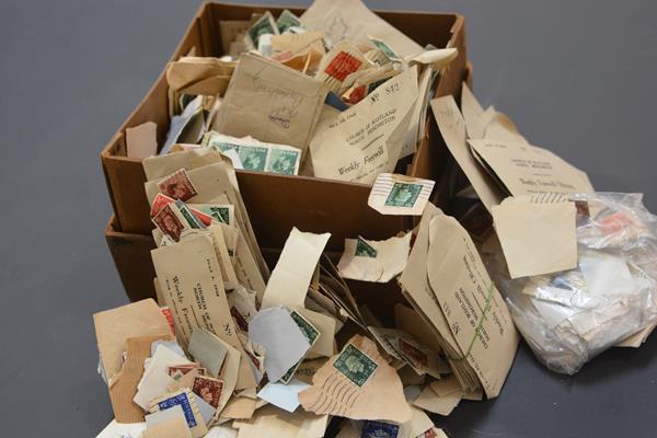 A cardboard box containing a loose stamp collection, GB and World, mostly 20th century