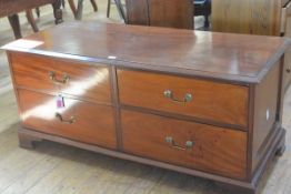 An Edwardian mahogany low chest in the Georgian taste, the rectangular moulded top above four