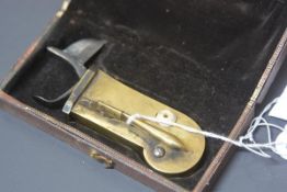 A 19th century brass and steel veterinary fleam, in its original fitted case. 11.5cm