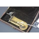 A 19th century brass and steel veterinary fleam, in its original fitted case. 11.5cm