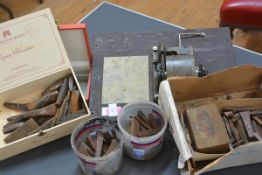 A group including chisels, a gramophone movement and a jewellery case.