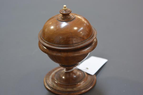 A 19th century ivory-mounted walnut string holder, of spherical form, with urn finial. 15.5cm