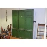 A late 19th century green-painted country bookcase cabinet, the upper section with three panelled