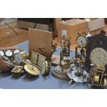 A box containing a quantity of table and other clocks and clock parts including 100-day clocks,