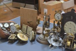 A box containing a quantity of table and other clocks and clock parts including 100-day clocks,