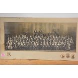 A large black and white photograph of an orchestra, c. 1900, the musicians set against an imposing