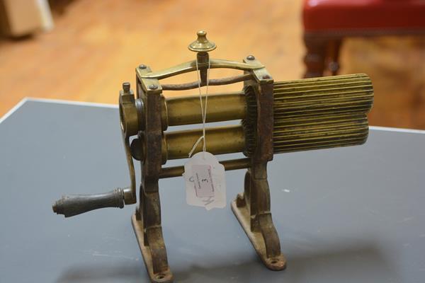 A brass table top crimping machine, second quarter 19th century, with urn finial. 25cm