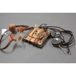 A pair of bakelite 2000 Ohm crystal radio set headphones, a table top bulb and a padded brace. (3)