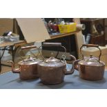 Three late 19th century copper kettles of various sizes and shapes. (3)