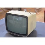 A vintage Grundig plastic-cased portable television. 25cm by 30cm