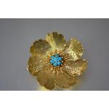 A vintage turquoise mounted yellow metal brooch, realistically modelled as a flowerhead, the