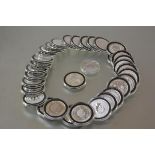 Thirty-four fine silver coins, mostly Commonwealth and one ounce.