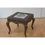 A 19th century walnut stool, the upholstered square seat centred by a beadwork panel worked as