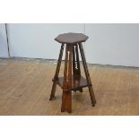 An Arts & Crafts walnut occasional table or stand in the Liberty style, the octagonal top raised