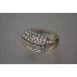 An 18ct gold diamond bombe ring, set with seven rows of round brilliant-cut diamonds, on a