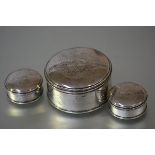 A set of three George II silver boxes, maker's mark EP, London 1758, each circular, the domed covers