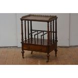 A mid-Victorian walnut canterbury, the rectangular moulded top with pierced brass gallery raised