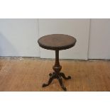 A mid-19th century inlaid walnut tripod table, the circular top with scalloped rim and centred by an
