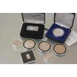 A small group of silver coins, one ounce ingot, 2.5g ingot, four foreign one ounce coins stamped "