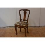 A Dutch inlaid walnut side chair, 19th century, with scroll and floral-carved back enclosing a