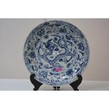 A large Xuande style blue and white porcelain dish, early 20th century, painted to the well with a