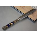A late 19th century silver-plate mounted enamel handled paper knife, the handle enamelled in gilt