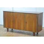 H. Morris & Co., Glasgow, a 1960's walnut sideboard, the rectangular top over three doors