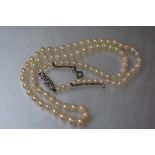 A diamond set single strand graduated cultured pearl necklace, the 9ct white gold oval clasp set