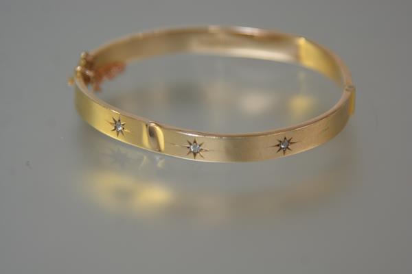 A diamond-set 9ct gold bangle, the hollow bangle (dented), set with three old-cut diamonds (a/f).