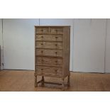 A limed oak tallboy, c. 1920, the rectangular top above two short and five long graduated drawers,