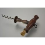 A 19th century corkscrew, the turned wooden handle with brush. 14.5cm