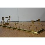 A brass fender in the Art Nouveau taste, early 20th century, formed from whiplash curves and