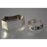 Two silver napkin rings: the first, inlaid with panels of banded agate, hallmarked for Adie &