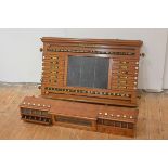 A handsome Edwardian Scottish oak billiards scoreboard and ball rack, John Taylor & Son,