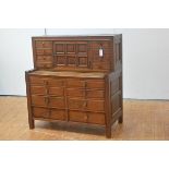 An unusual stained pine and oak estate office desk cabinet, c. 1910, the superstructure centred by a