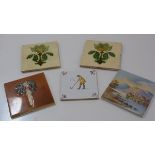 A pair of cabbage decorated Victorian tiles and another Delft style tile, a stylised floral Art