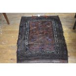 A Bokhara rug, the centre panel with three rows of five stylised flowerheads, enclosed within a