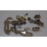 A group of silver charms, silver bracelets, padlocks etc inc. a figure in a bath. Total 82 grams