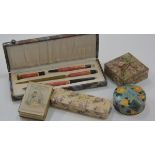 A 1930's marbled plastic desk set inc. pen, letter opener, seal stamp and pencil, in original fitted
