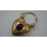 A Victorian yellow metal heart-shaped padlock with garnet cabochon. 4 grams gross