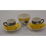 Bough Pottery: a pair of coffee cans and saucers decorated with floral borders on yellow ground,