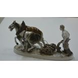 A large Continental porcelain group, Ploughman and his Horses. 19cm by 38cm