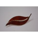 Aksel Holmsen, a Norwegian sterling silver and enamel brooch, of stylised leaf form, in shaded red