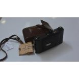 An Ensign folding camera complete with original leather travel case