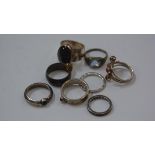 A group of silver semi-precious stone mounted rings including topaz, coral etc