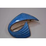 Aksel Holmsen, a Norwegian sterling silver and enamel brooch, of stylised ribbon form, in engine-