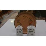 Two French enamelled storage jars, The and Pates, and a circular enamelled French floral-decorated